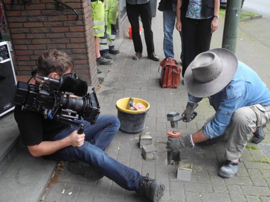 Der Künstler Gunter Demnig wird bei seiner Arbeit gefilmt